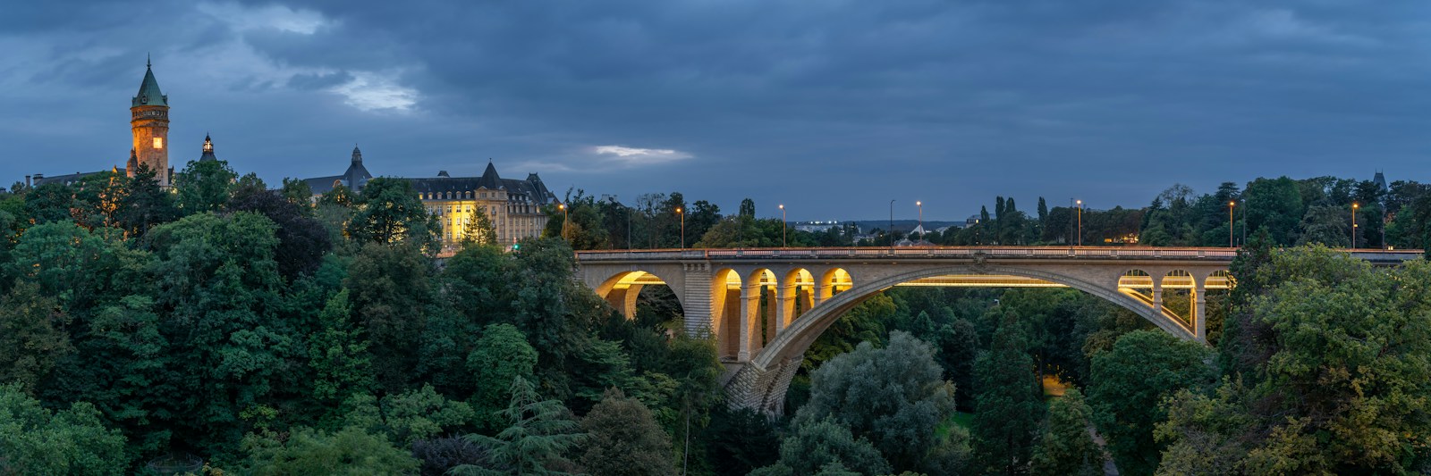 Adolphe Bridge and Luxembourg City's historic skyline at blue hour